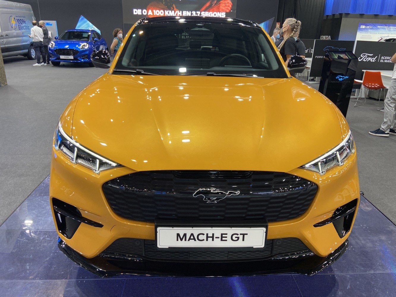 Front close-up of sporty electric SUV with LED headlights and black grille