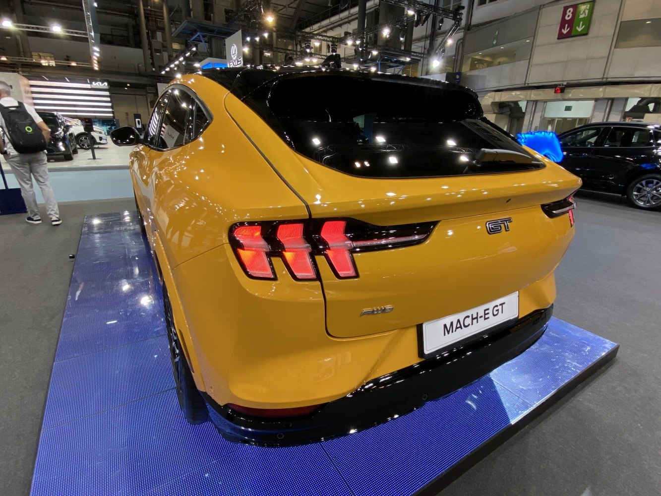 Rear view of a hatchback with signature tri-bar LED taillights in yellow paint.