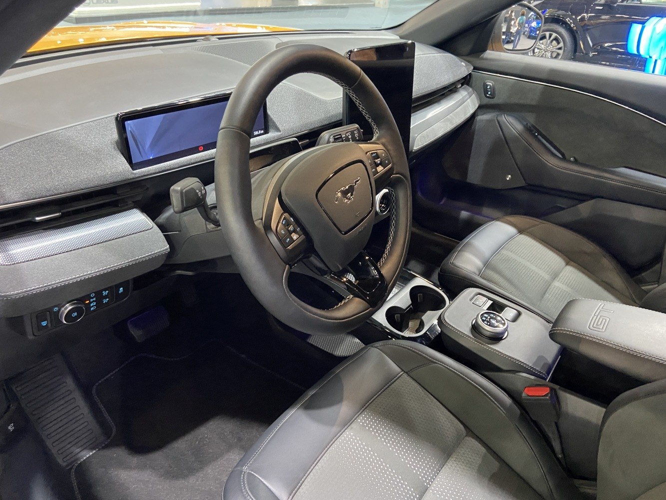Modern steering wheel and digital instrument cluster in a sleek vehicle interior