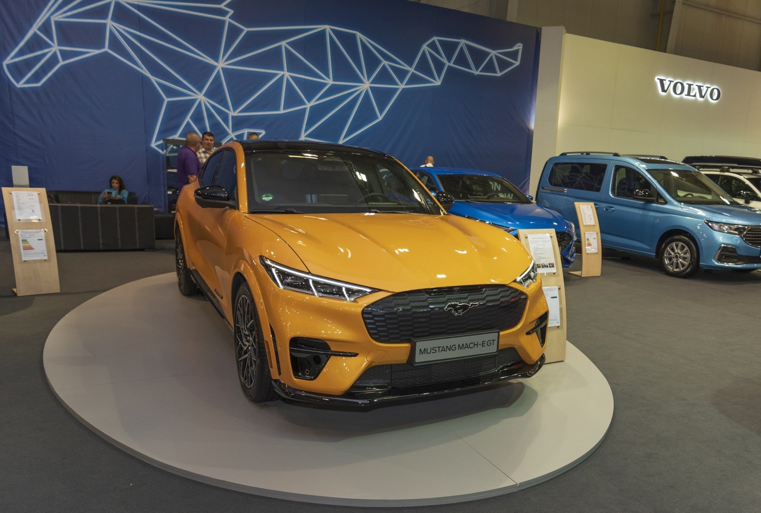 Yellow electric crossover SUV with Mustang-inspired front grille and sleek headlights