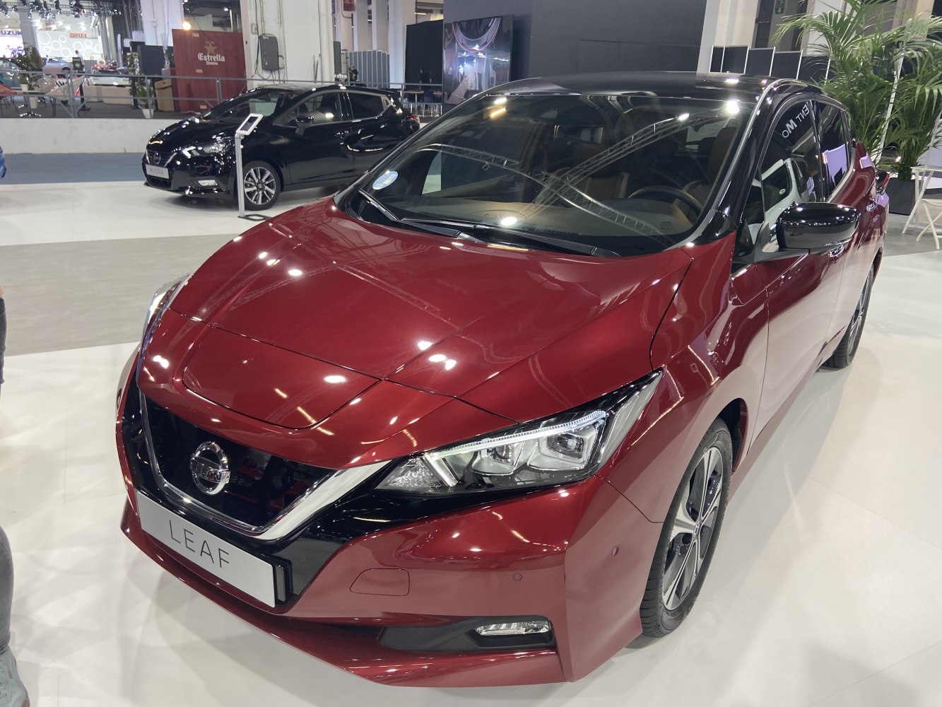 Front-side view of electric hatchback with sharp headlights and two-tone paint.