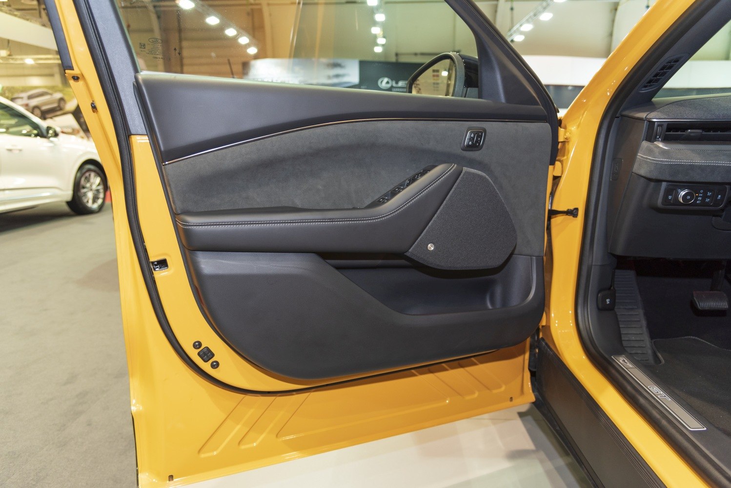 Modern interior door panel with integrated controls and speaker