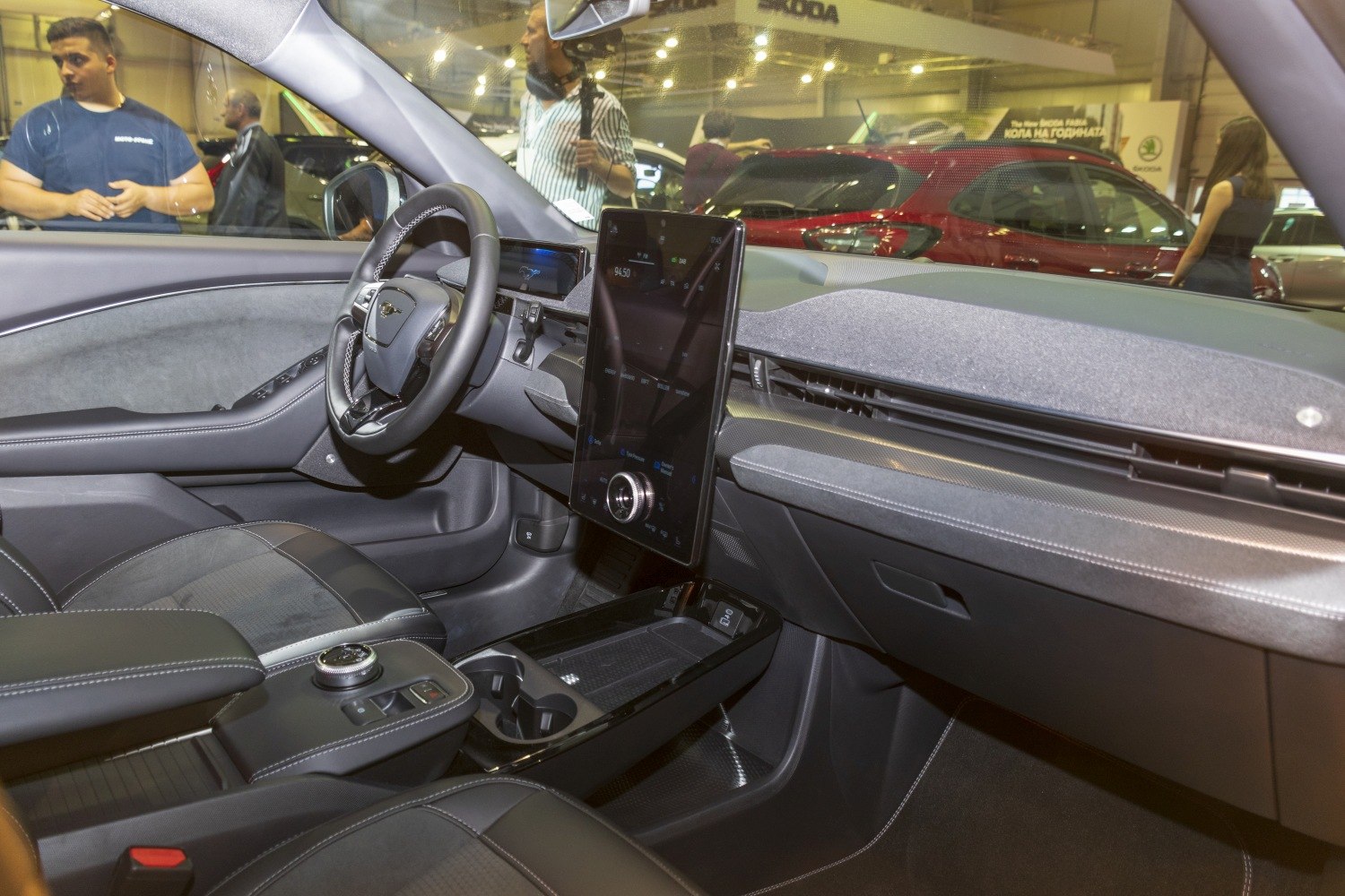 Electric SUV interior with vertical touchscreen and digital instrument cluster