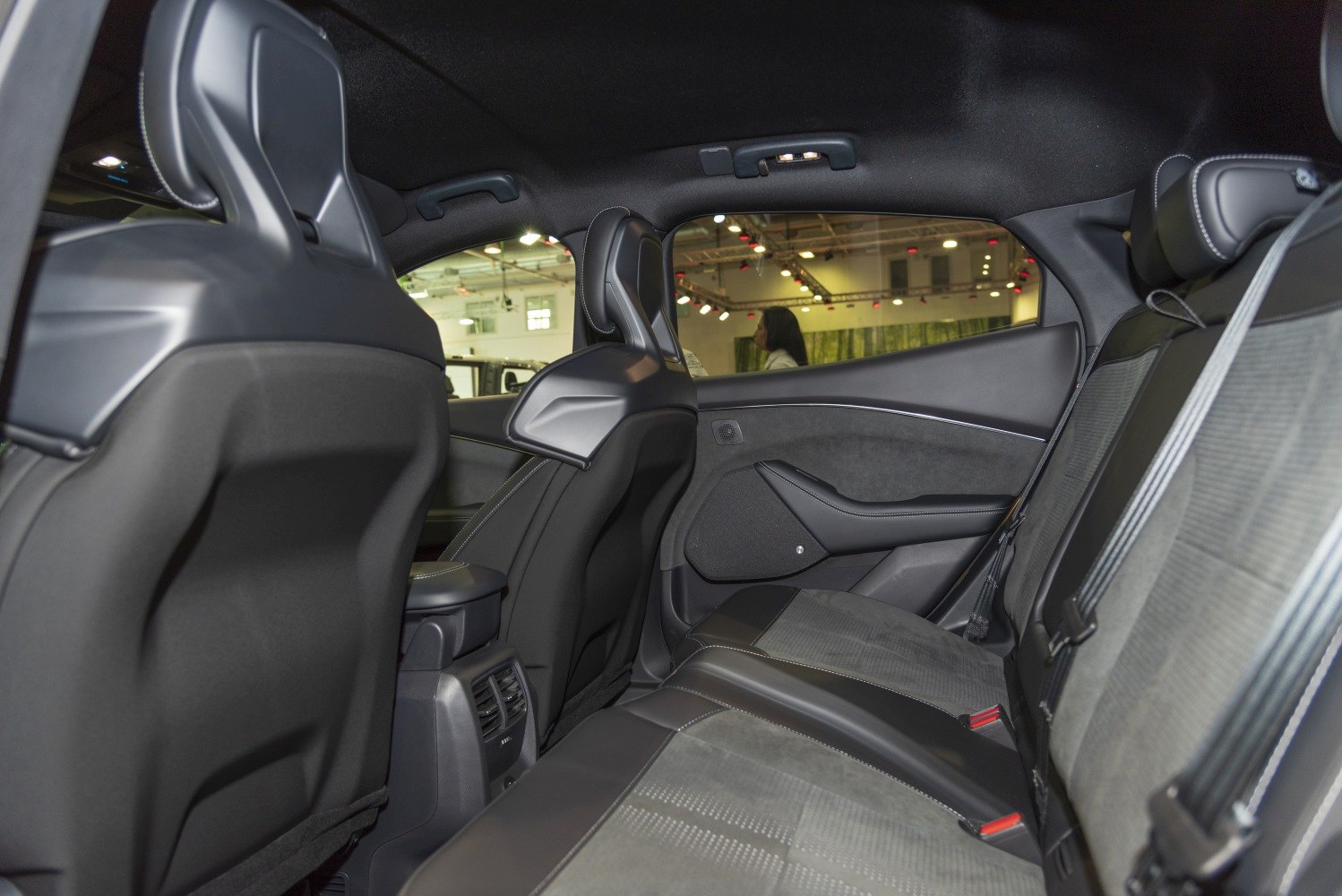 Rear interior seating and design with black upholstery and spacious layout