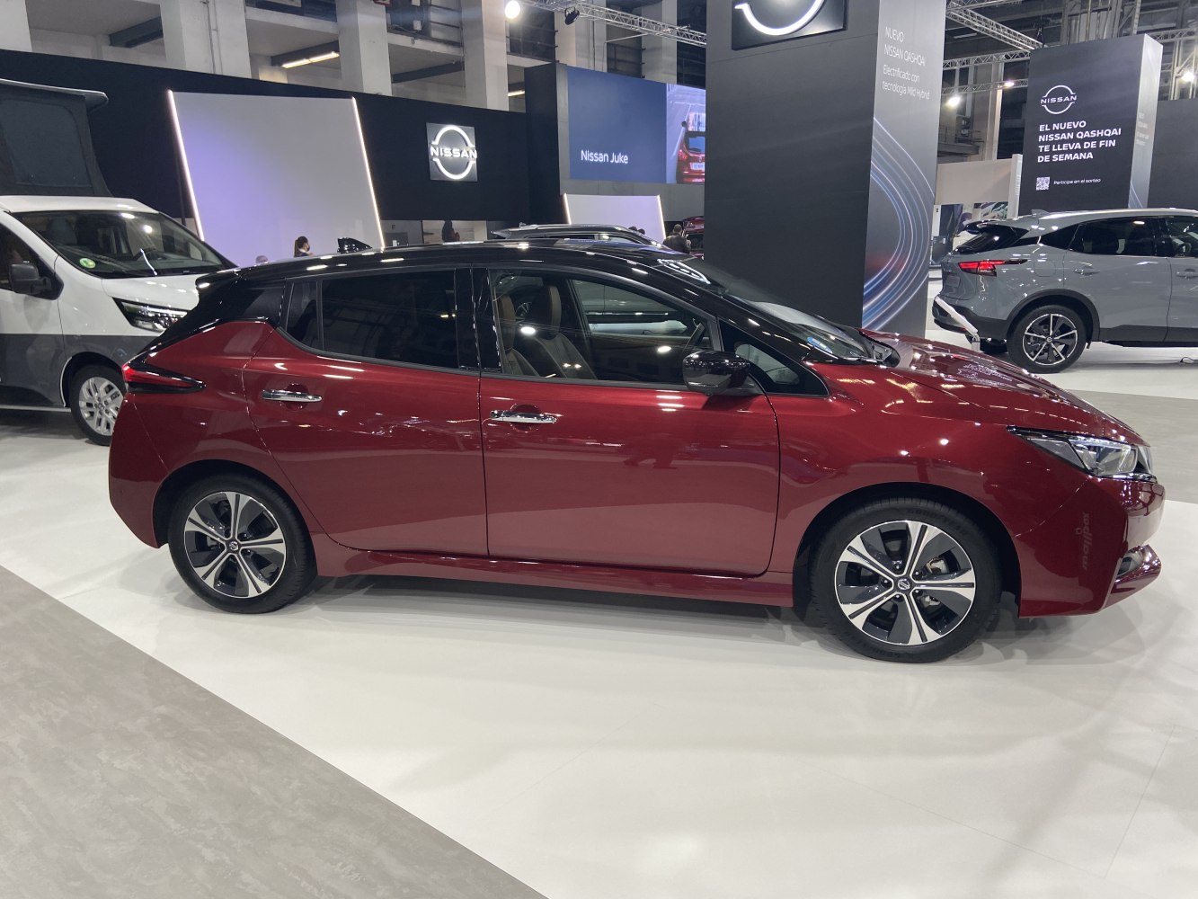 Sleek electric hatchback side view with sharp headlights and alloy wheels