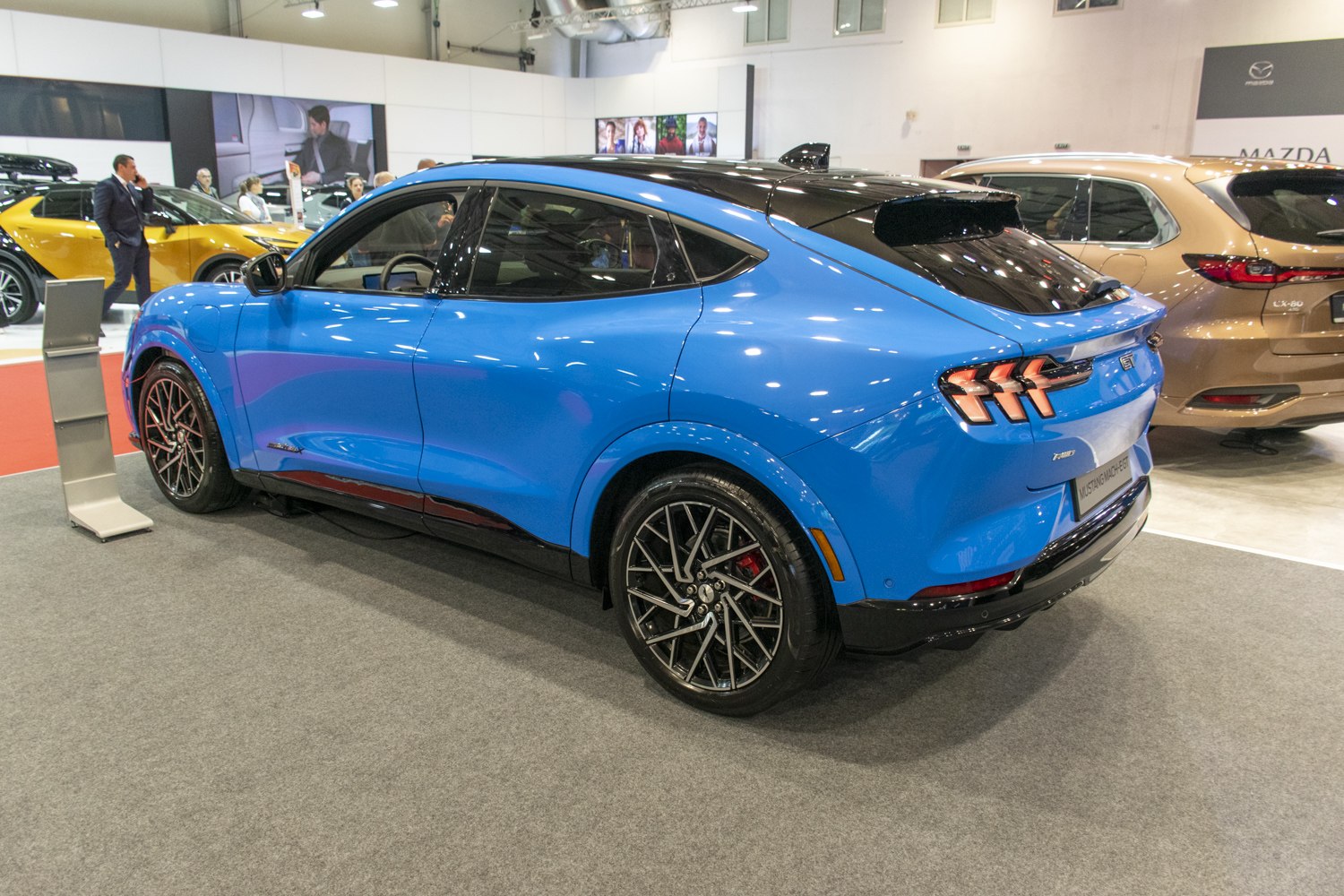 Blue SUV with black roof and distinctive triple-bar tail lights
