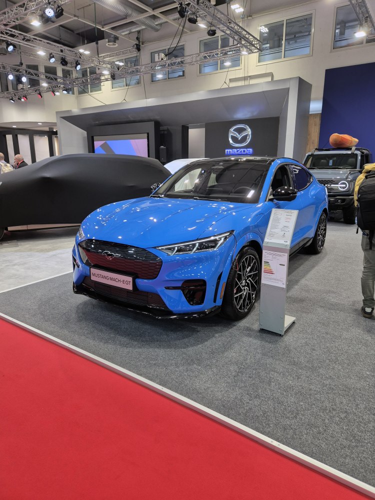 Front view of a blue electric SUV with aerodynamic design and stylish headlights