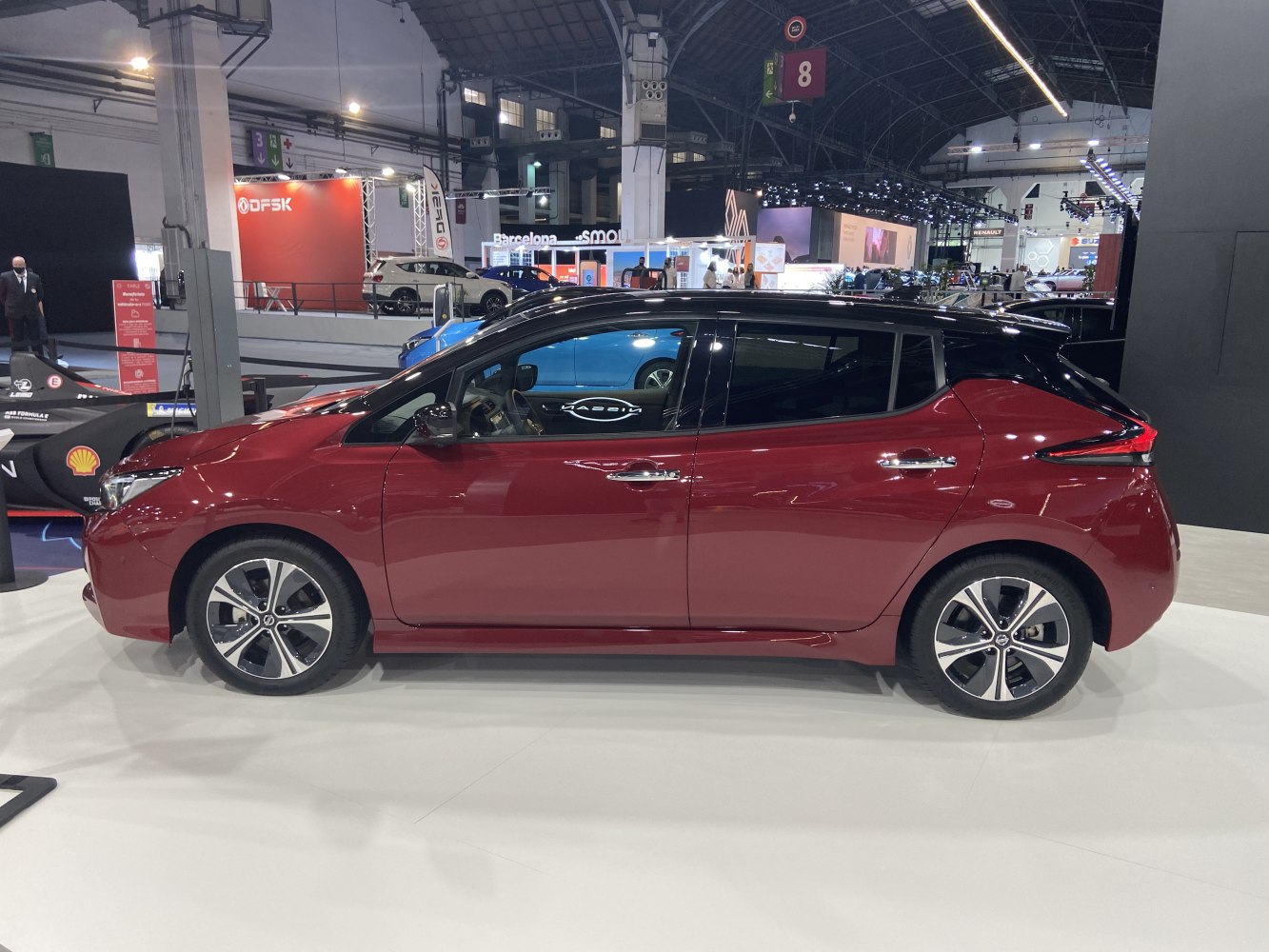 Red electric hatchback with black roof and alloy wheels