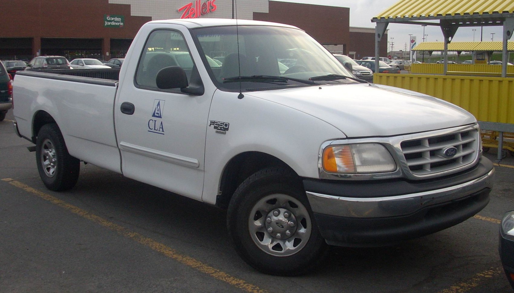 White regular cab pickup truck with F-250 XL badge and steel wheels