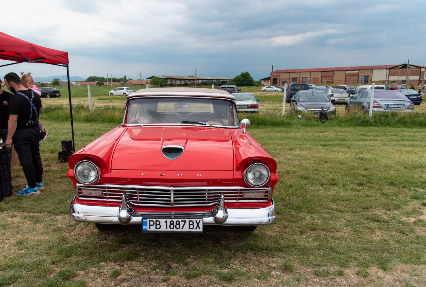 Front view of vintage car with chrome grille and round headlights