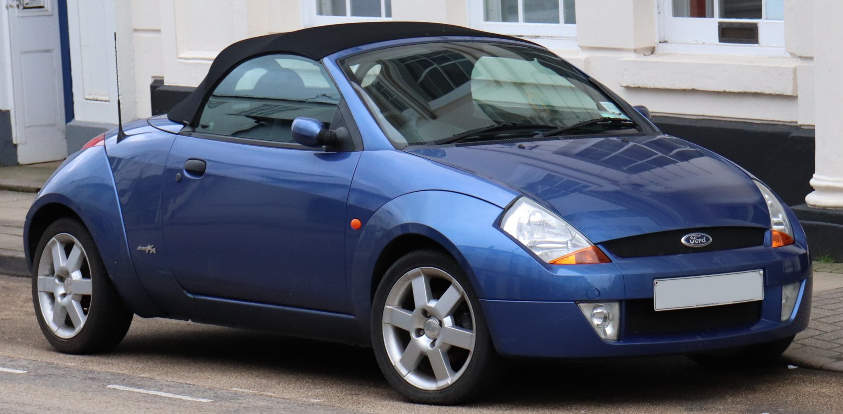Blue convertible with black soft top and alloy wheels