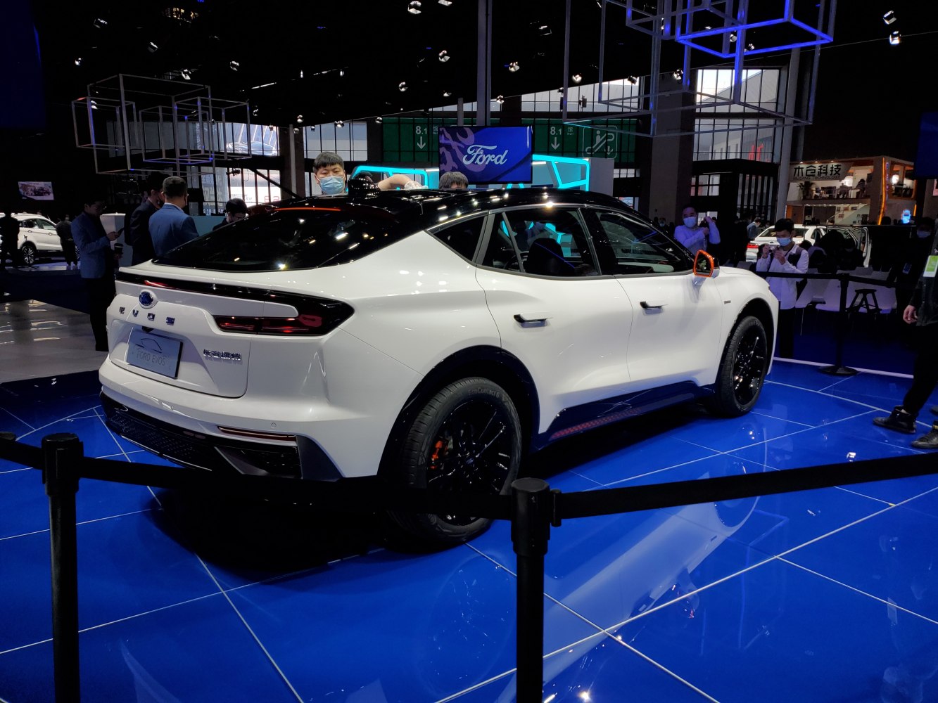 White electric SUV rear and side view with sleek tail lights and black wheels