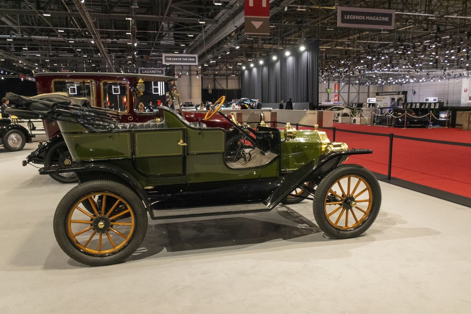 Open-top vintage vehicle with wooden-spoke wheels and brass accents