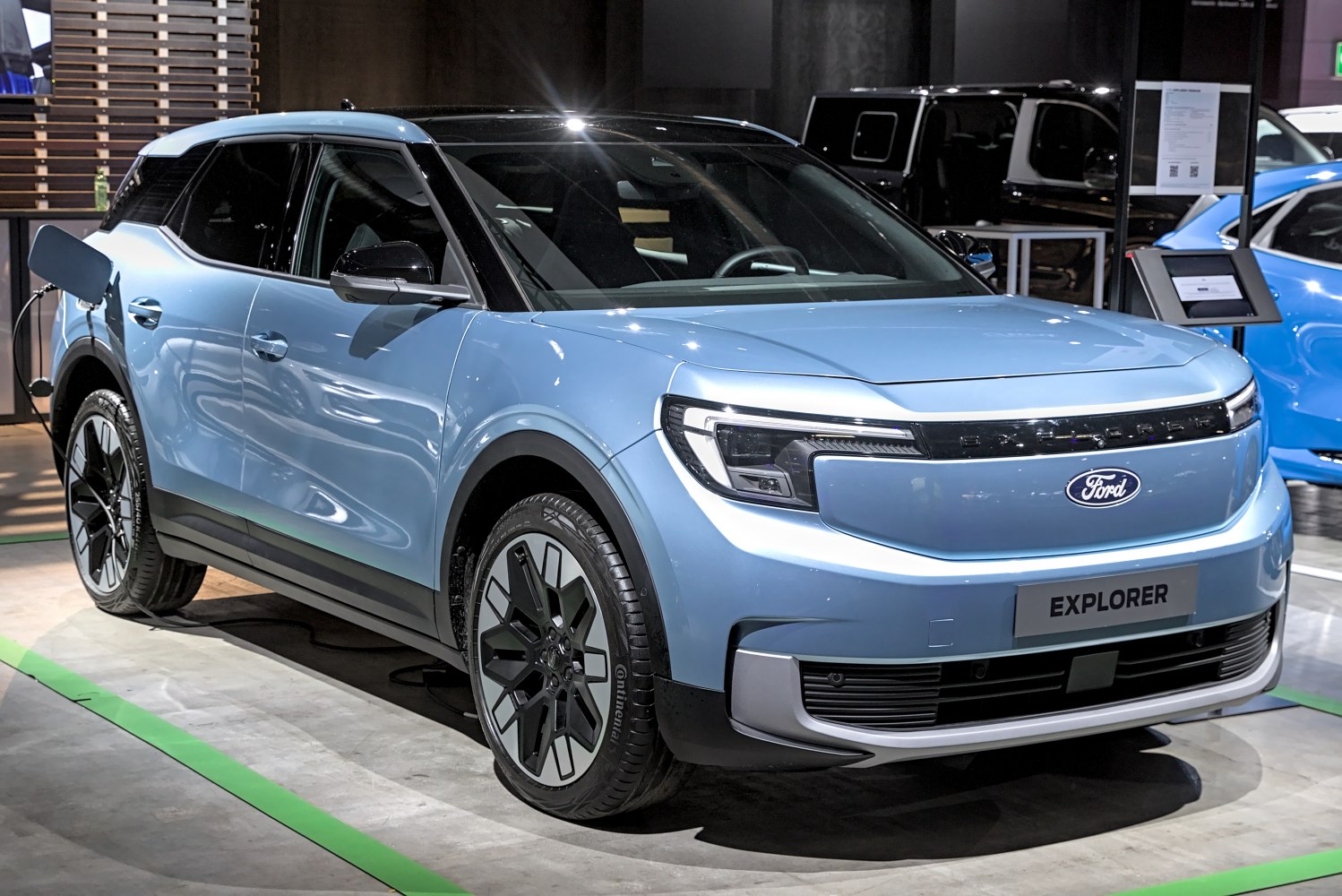 Electric SUV with front LED headlights and sleek blue exterior.