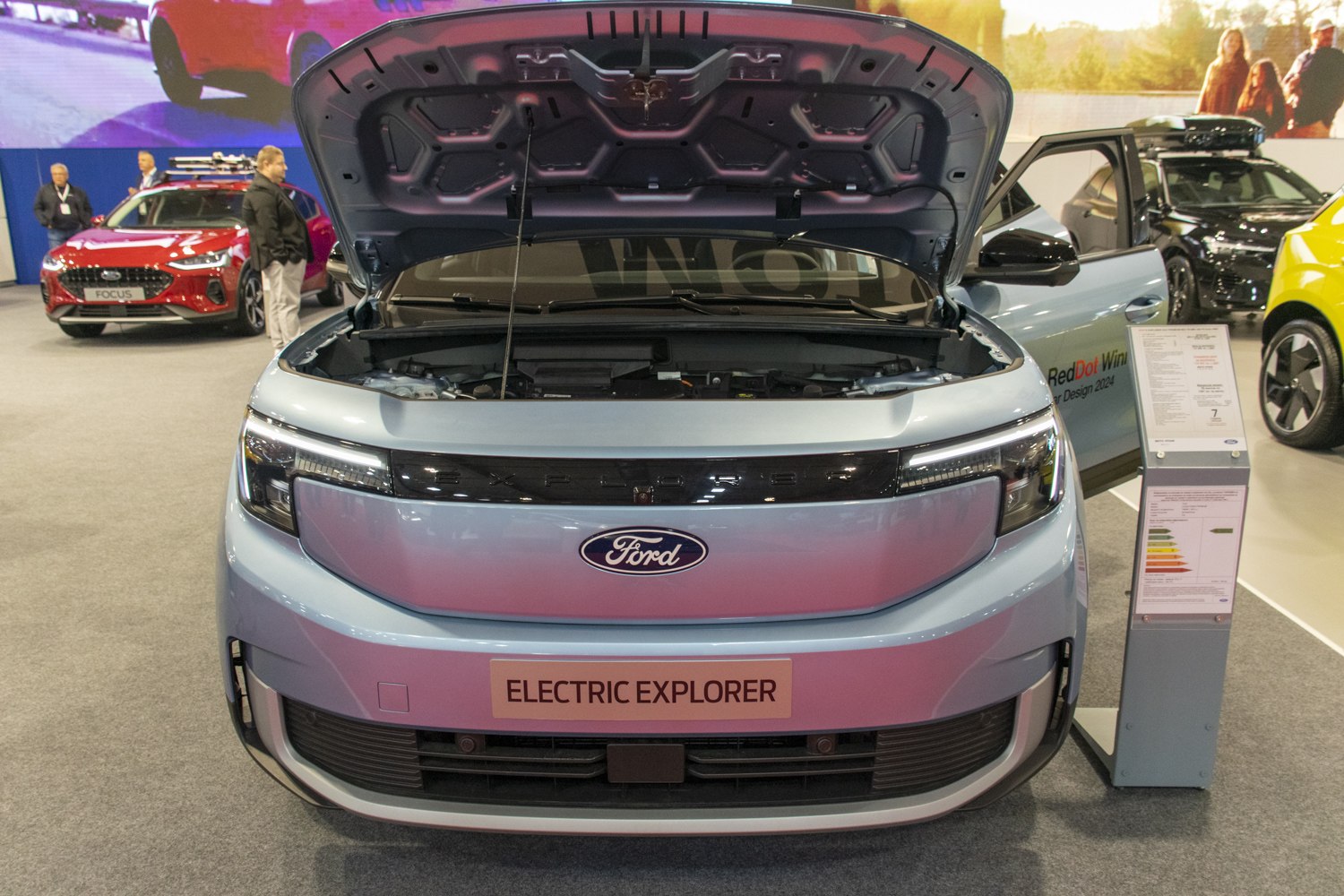 Front open hood and modern electric SUV front fascia close-up