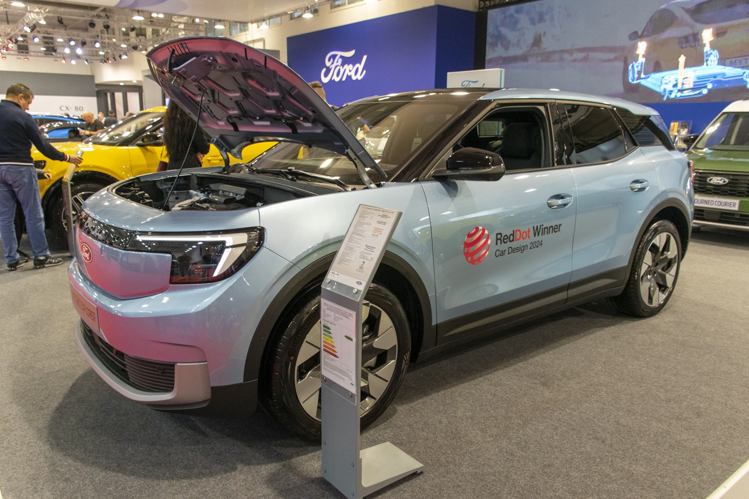 Electric SUV with open hood and modern design at dealership