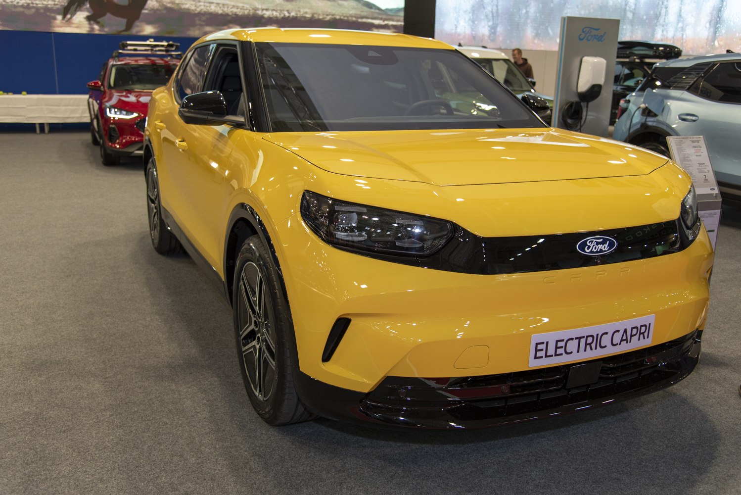 Yellow electric crossover with sleek headlights and aerodynamic design
