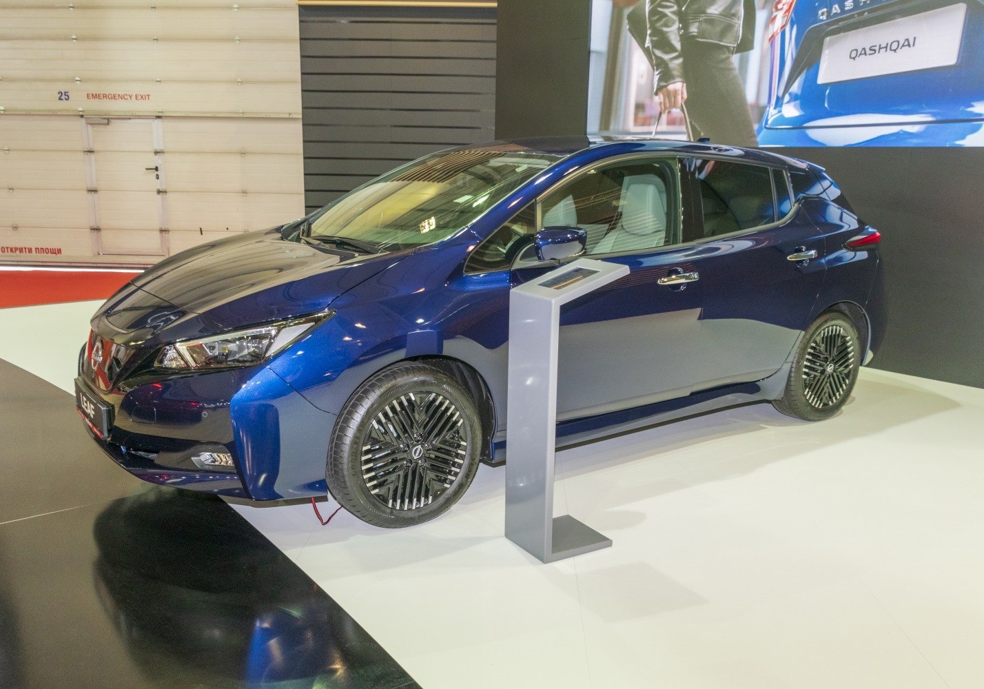 Blue electric hatchback with sharp headlights and aerodynamic wheels