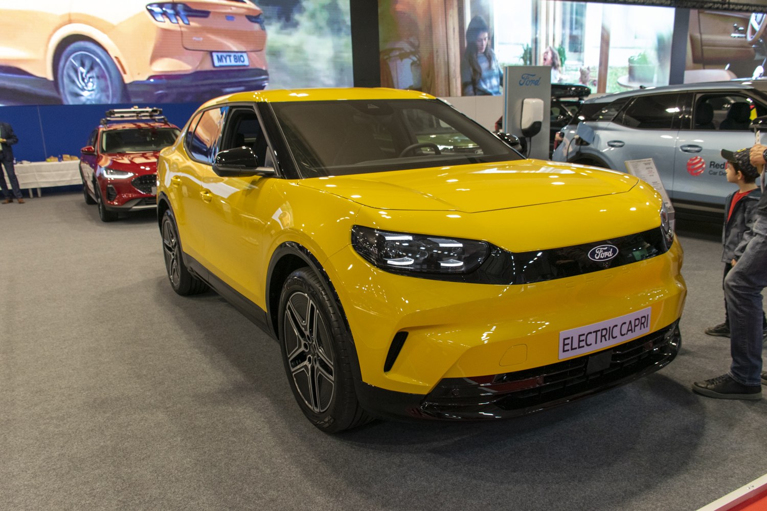 Yellow electric crossover front view with modern headlamps