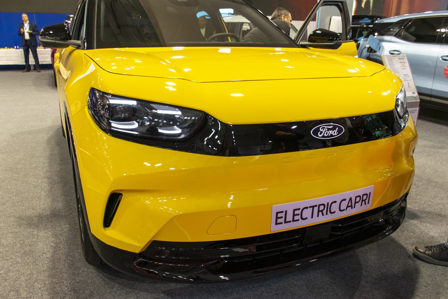 Sleek yellow electric car front with modern LED headlights