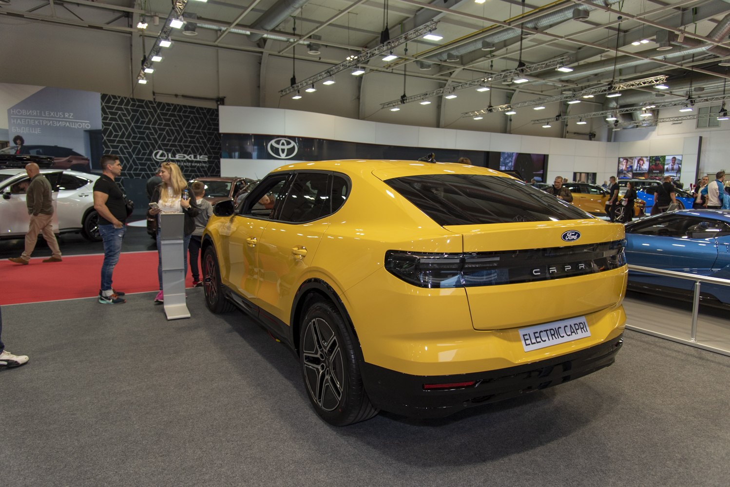 Yellow electric SUV rear with sleek LED taillights and tinted windows