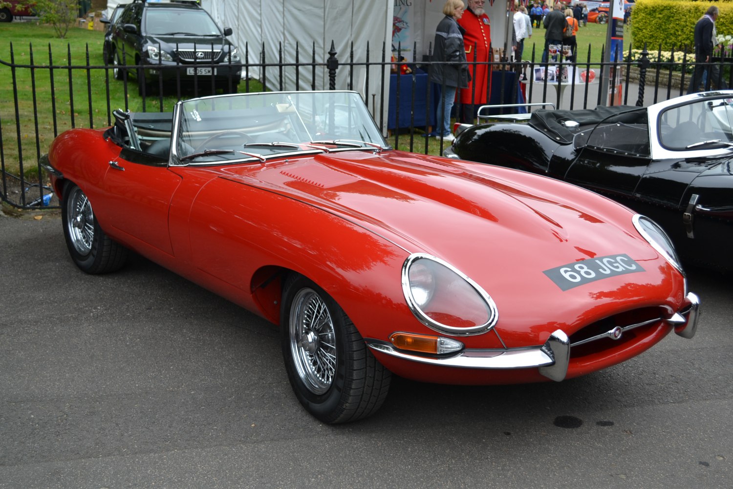 Sleek red convertible with smooth curves and wire wheels