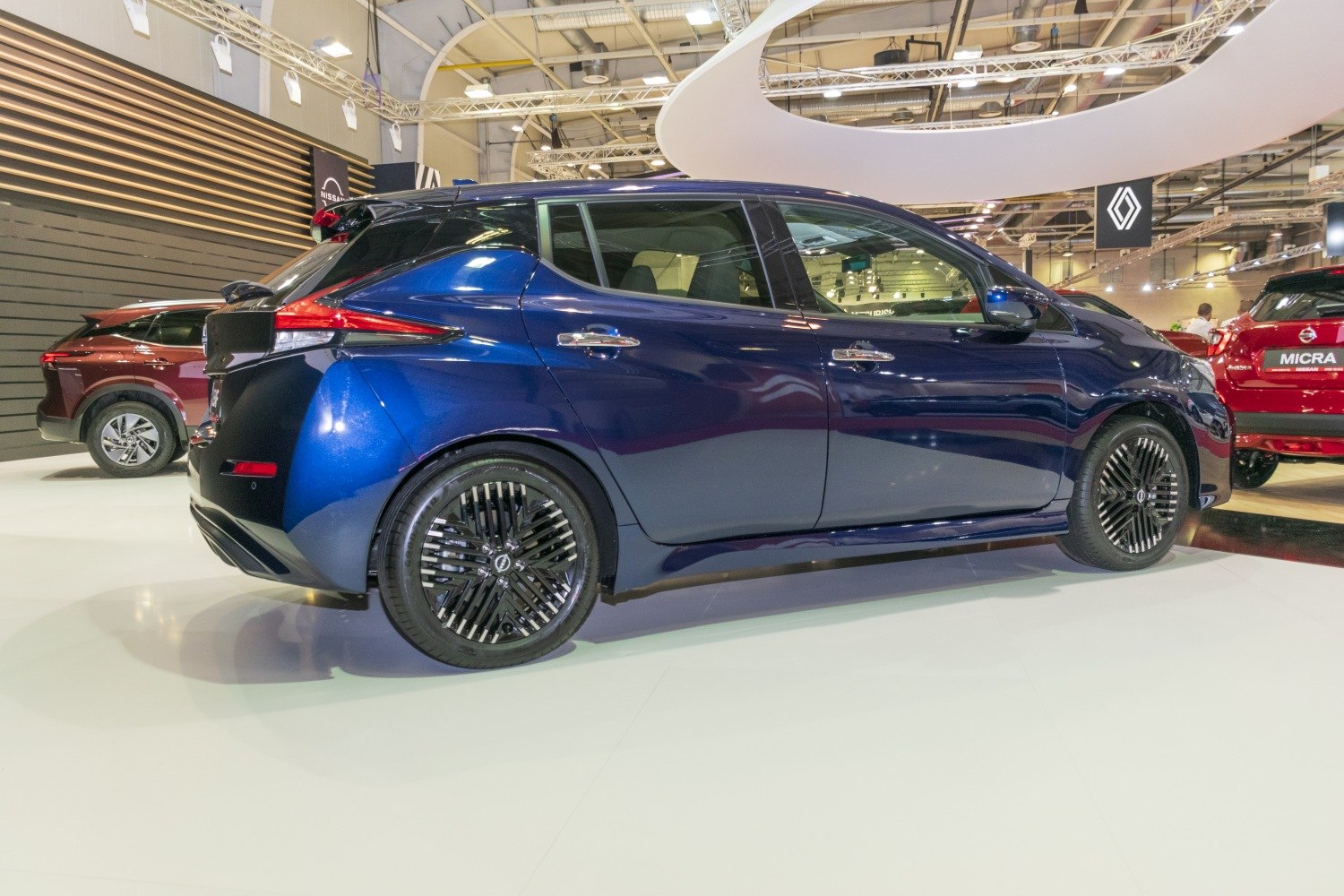 Side profile of blue electric hatchback with alloy wheels