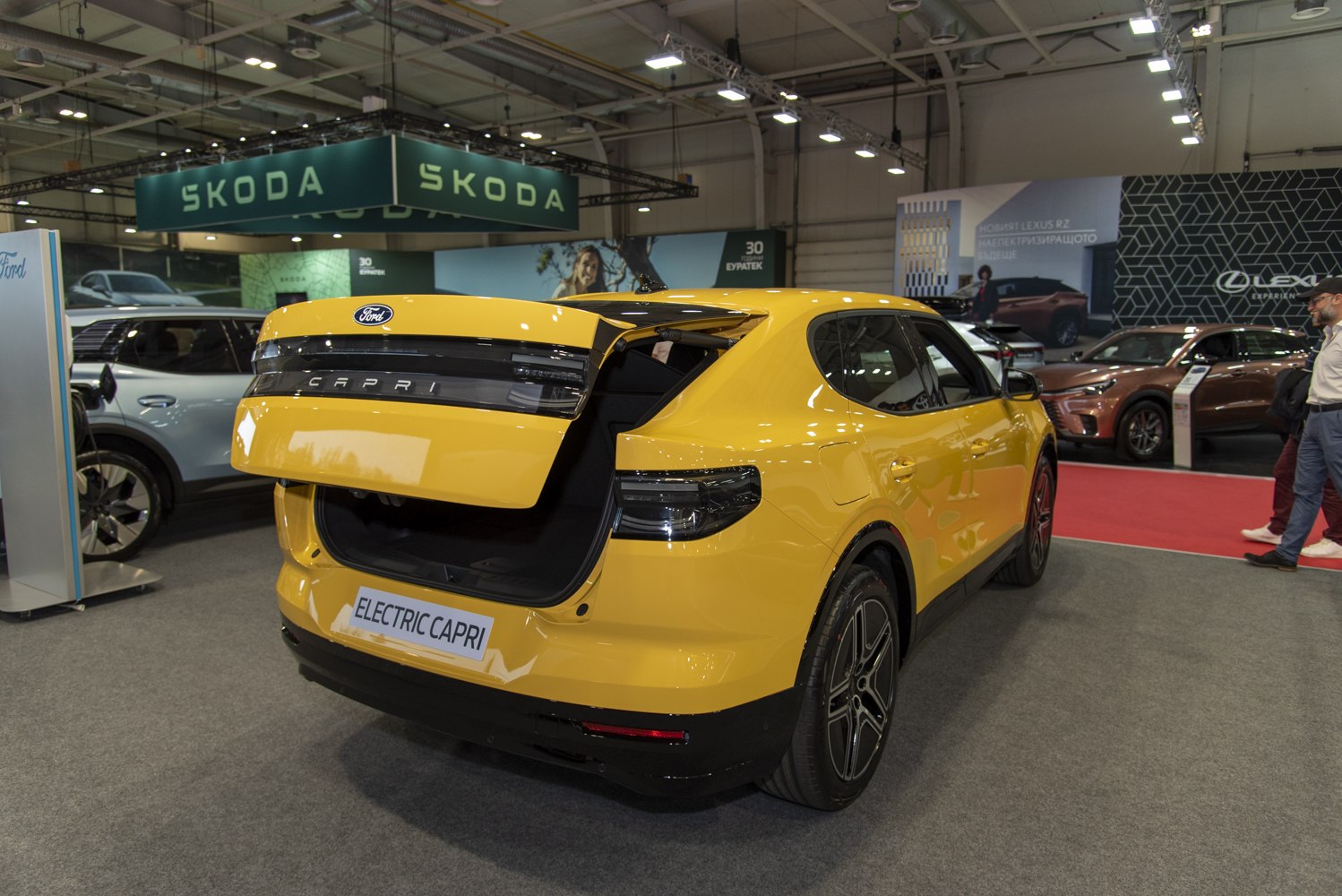 Yellow hatchback with open tailgate and modern rear design