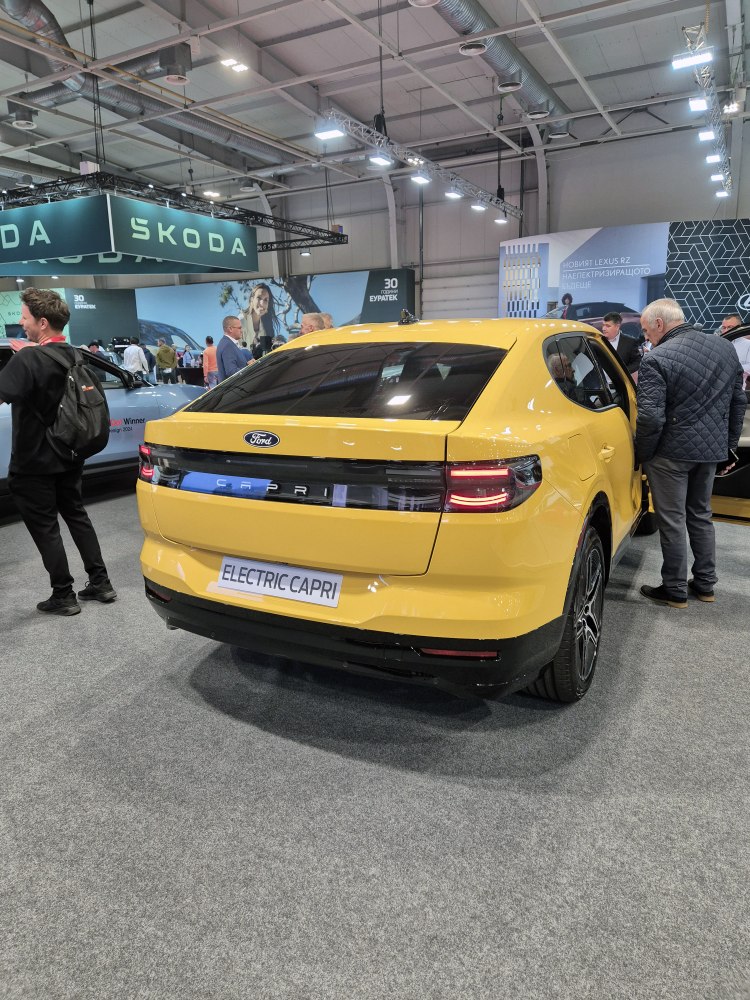 Rear view of yellow electric hatchback with LED taillights