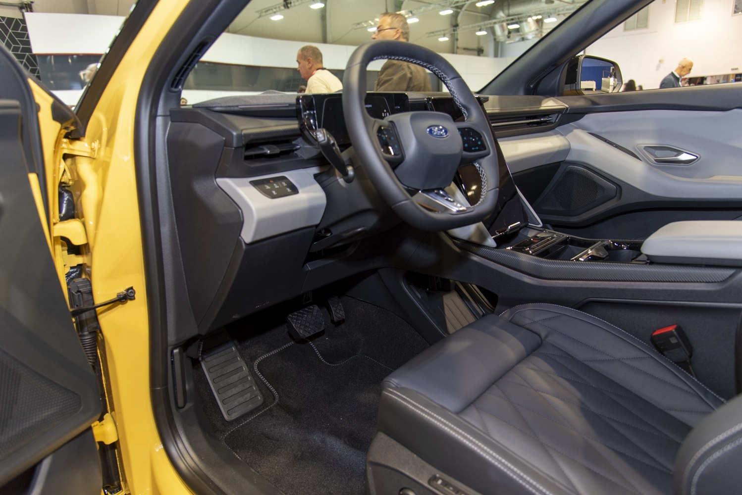 Modern EV steering wheel and dashboard interior with premium seats