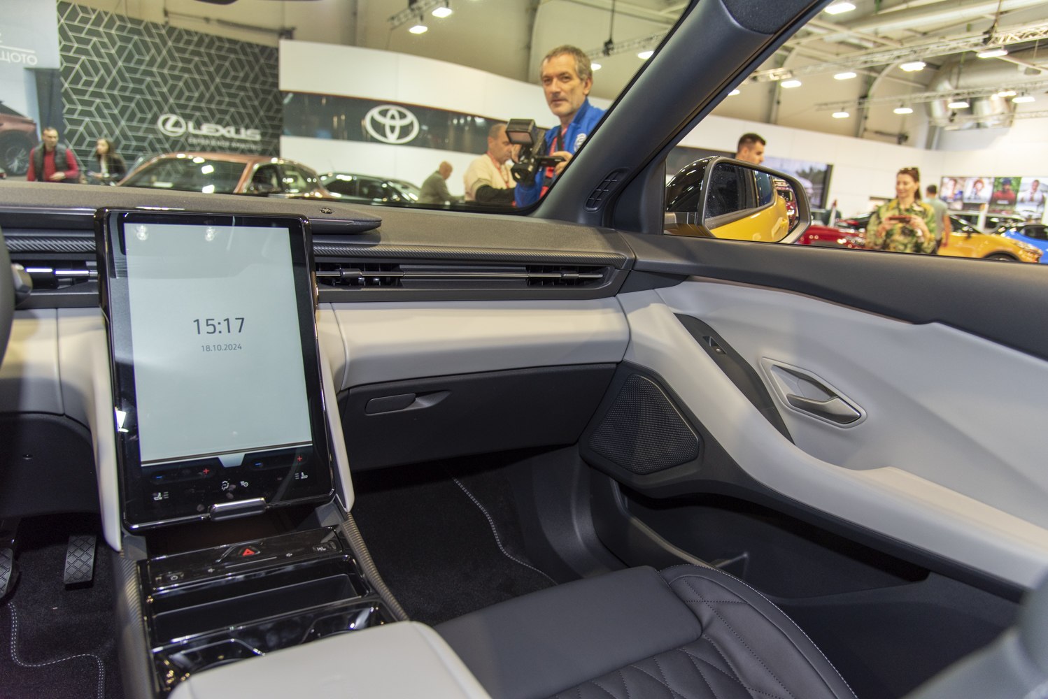 Modern electric car interior with large vertical touchscreen and sleek dashboard