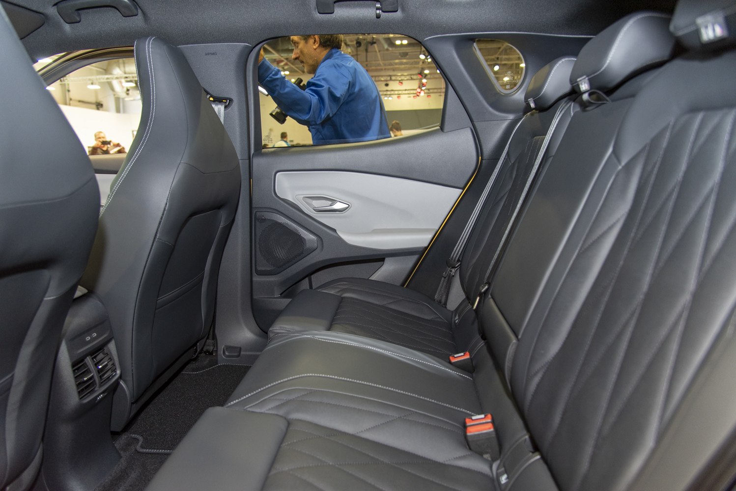 Rear interior with black leather seats and modern door panel