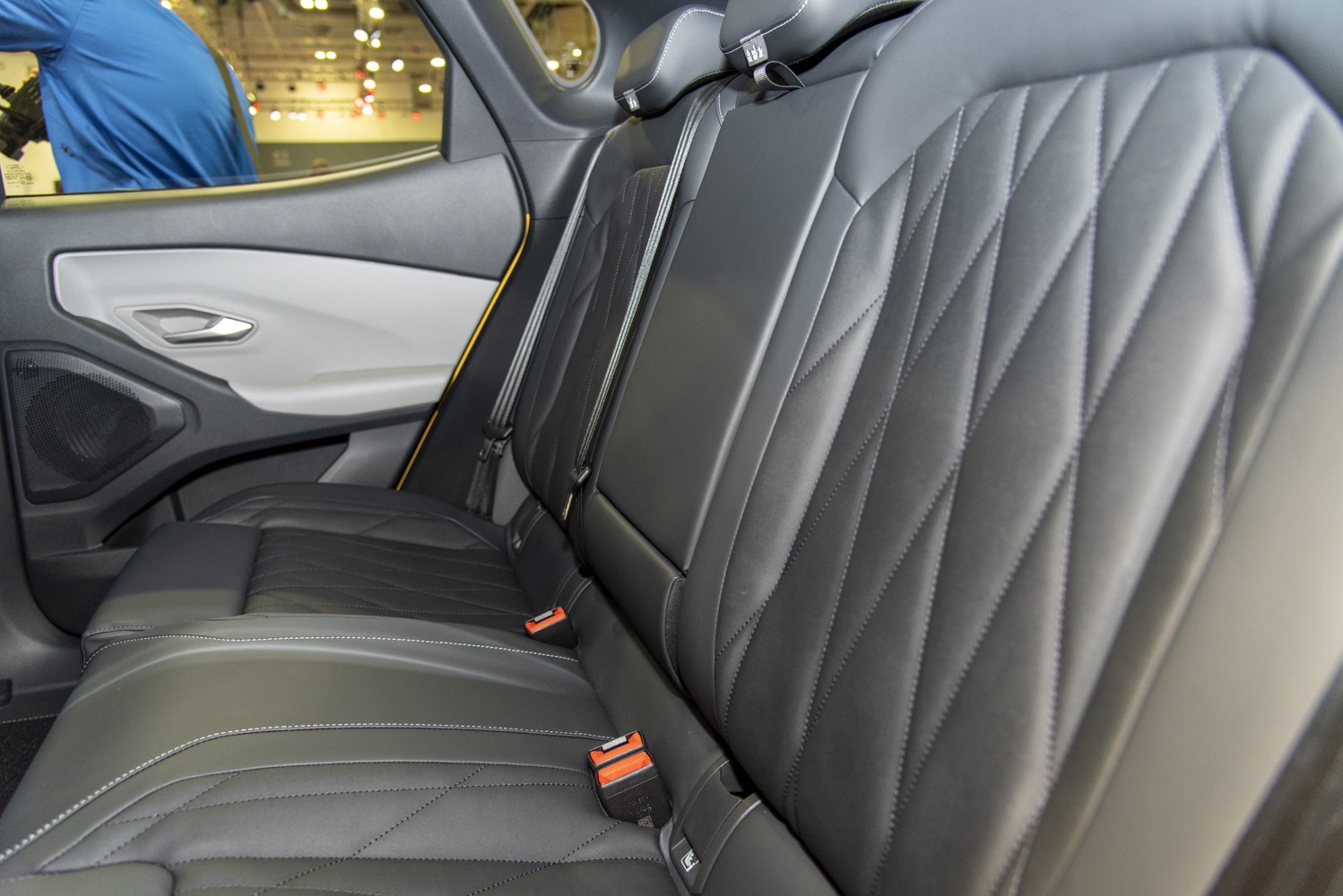 Luxury rear leather seats with detailed stitching and modern door panel.