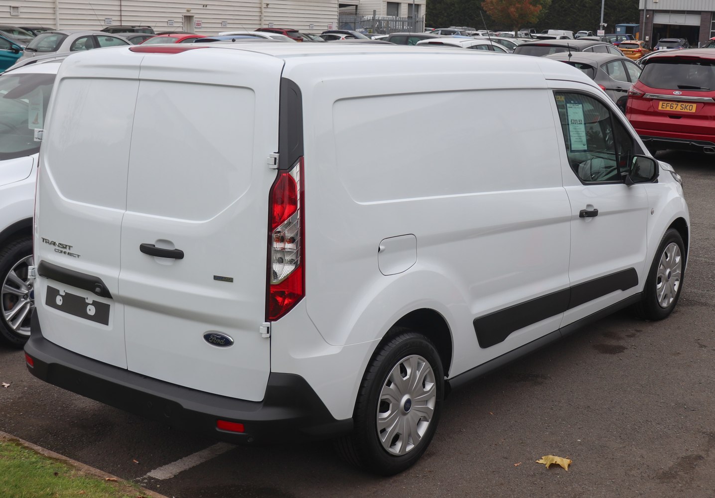 Rear-side view of a white panel van L2 with large cargo doors