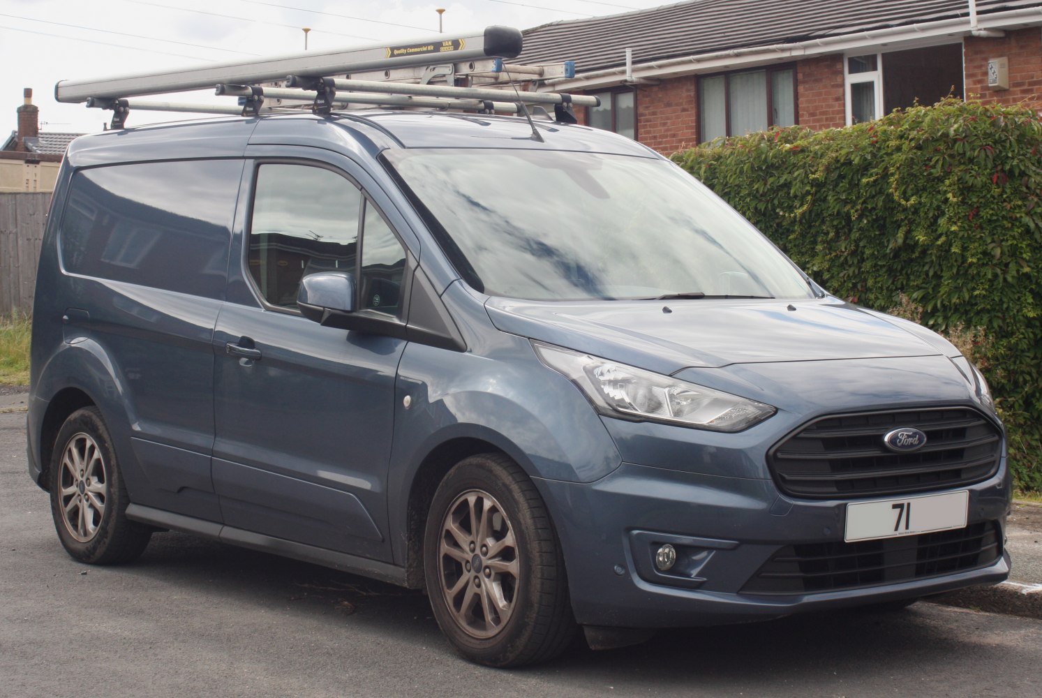 Front side view of panel van with roof rack