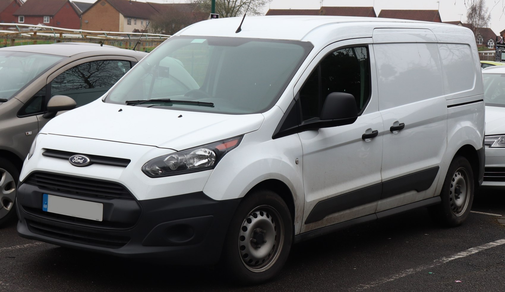White panel van with black trim and steel wheels, front-side view