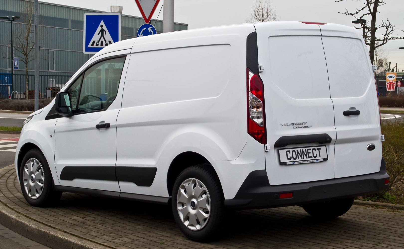 Rear and side view of a white panel van with compact cargo space.
