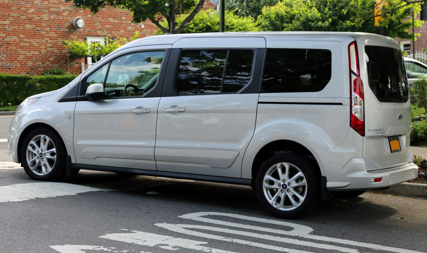 Side view of a white van with tinted windows and alloy wheels