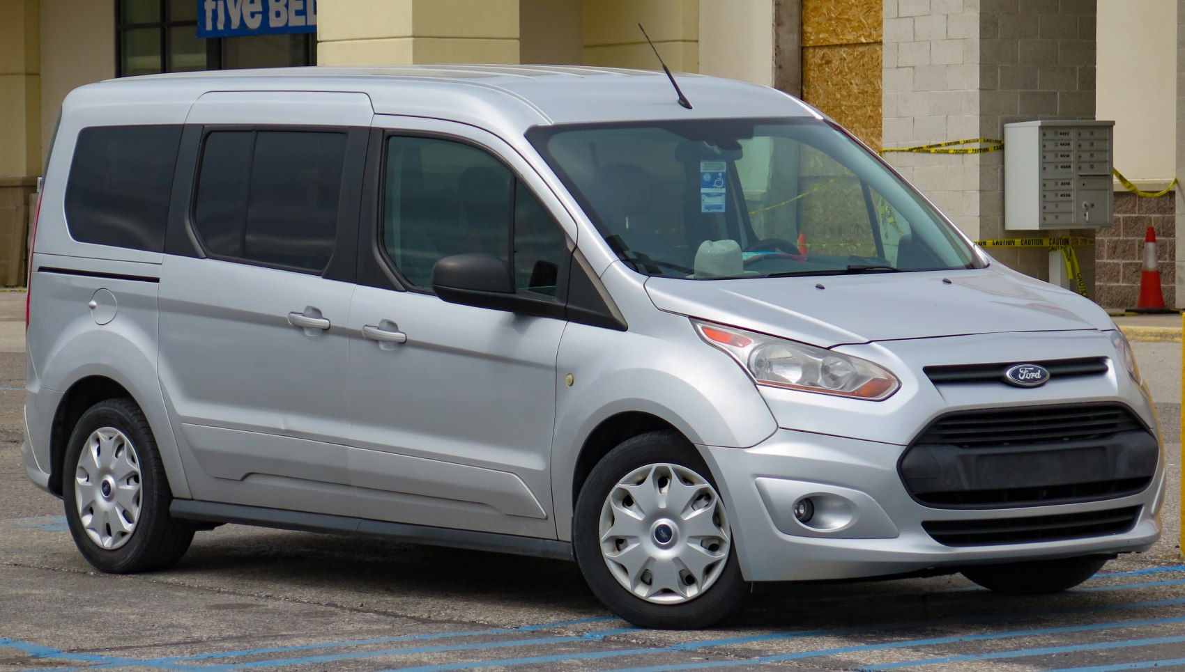 Silver minivan with front side view and black grille