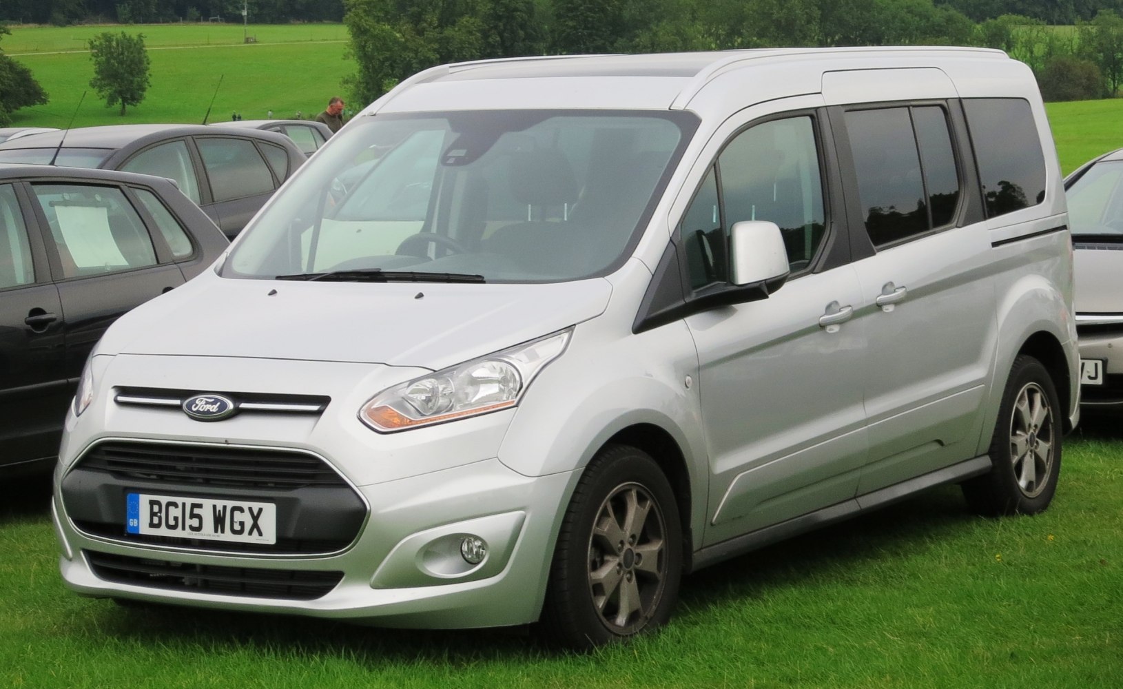 Silver multi-purpose van with distinct front grille and large side windows
