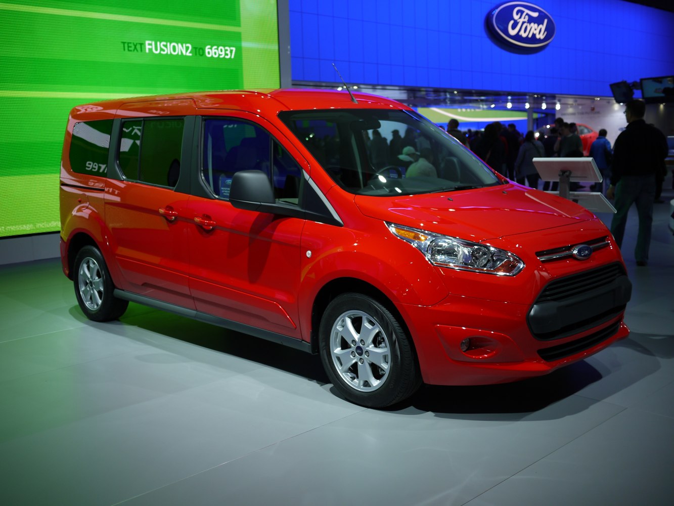 Red compact van with sliding side doors and modern headlights