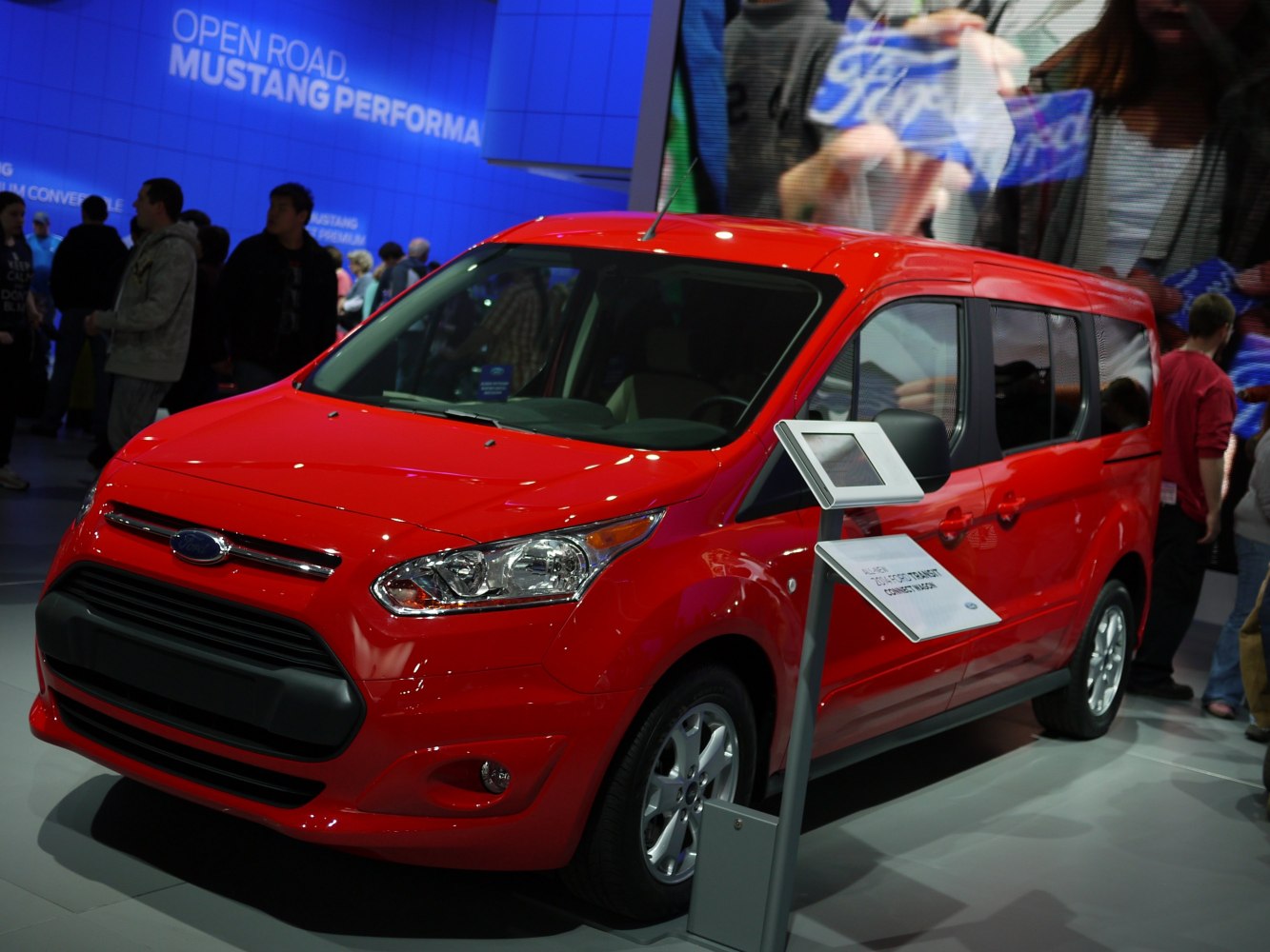 Red van with sleek headlights and aerodynamic shape