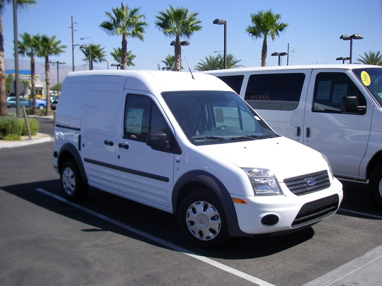 White high roof panel van with sliding side door and black trim