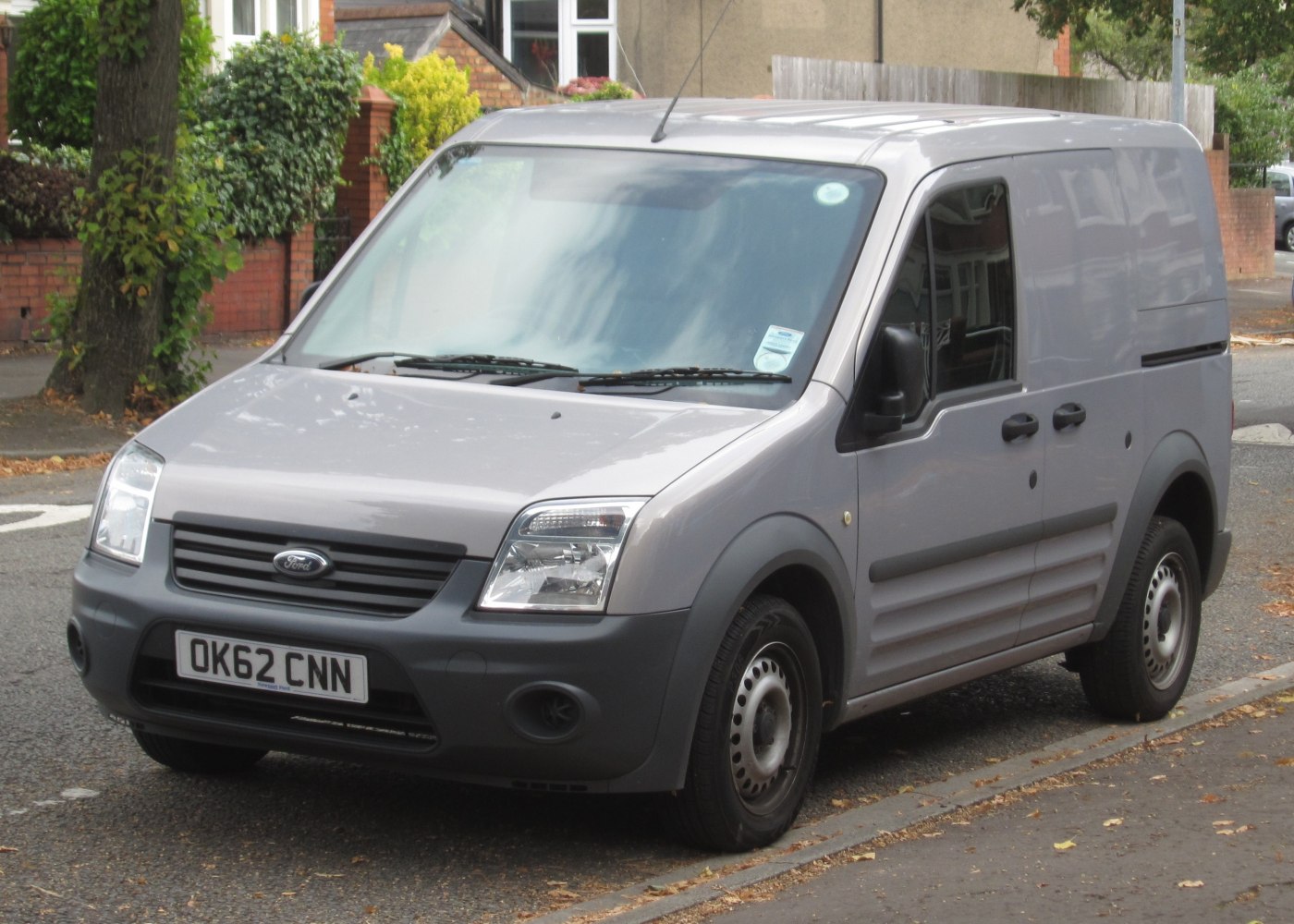Compact grey panel van with front grille and rectangular headlights