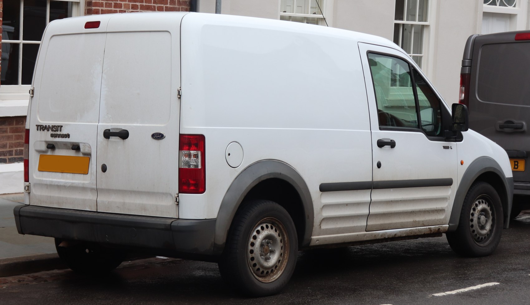 Rear and side view of a white panel van with dual rear doors and steel wheels