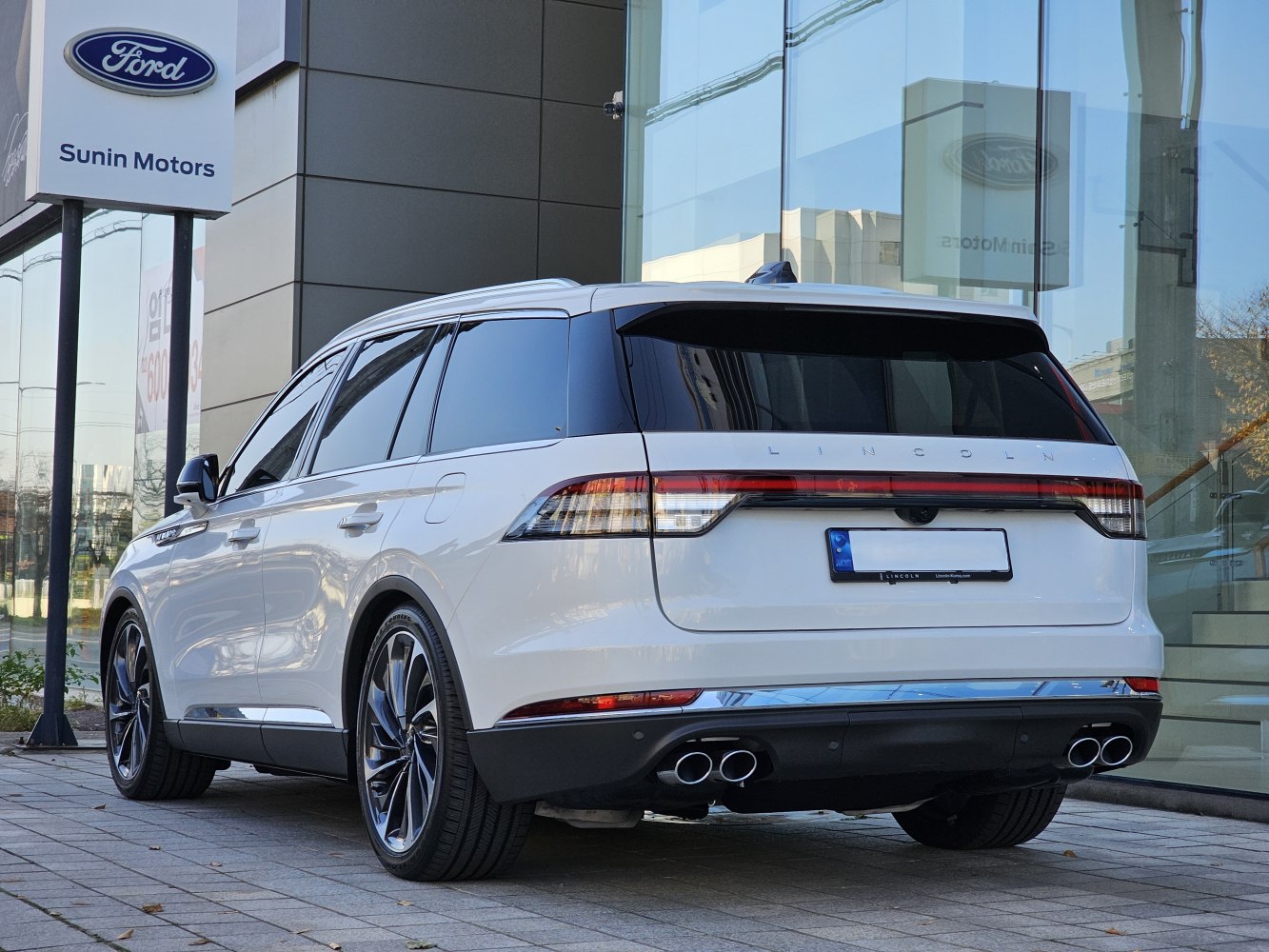 Rear view of luxury SUV with quad exhaust and sleek taillights