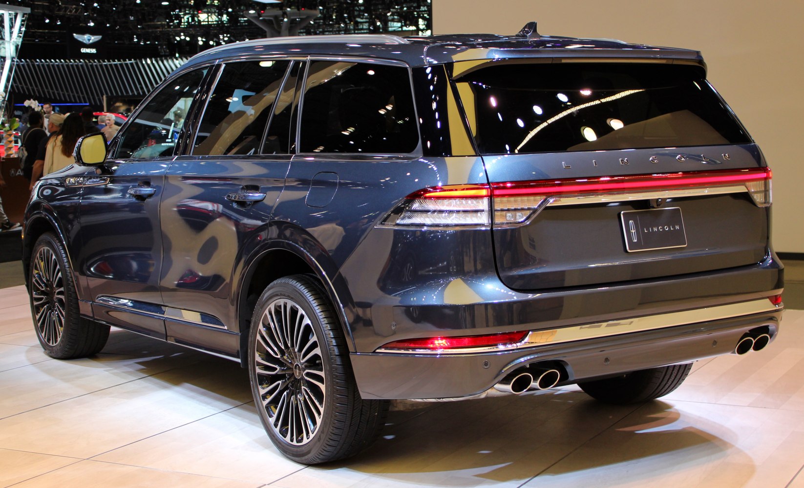 Luxury SUV with sleek rear design and quad exhaust pipes