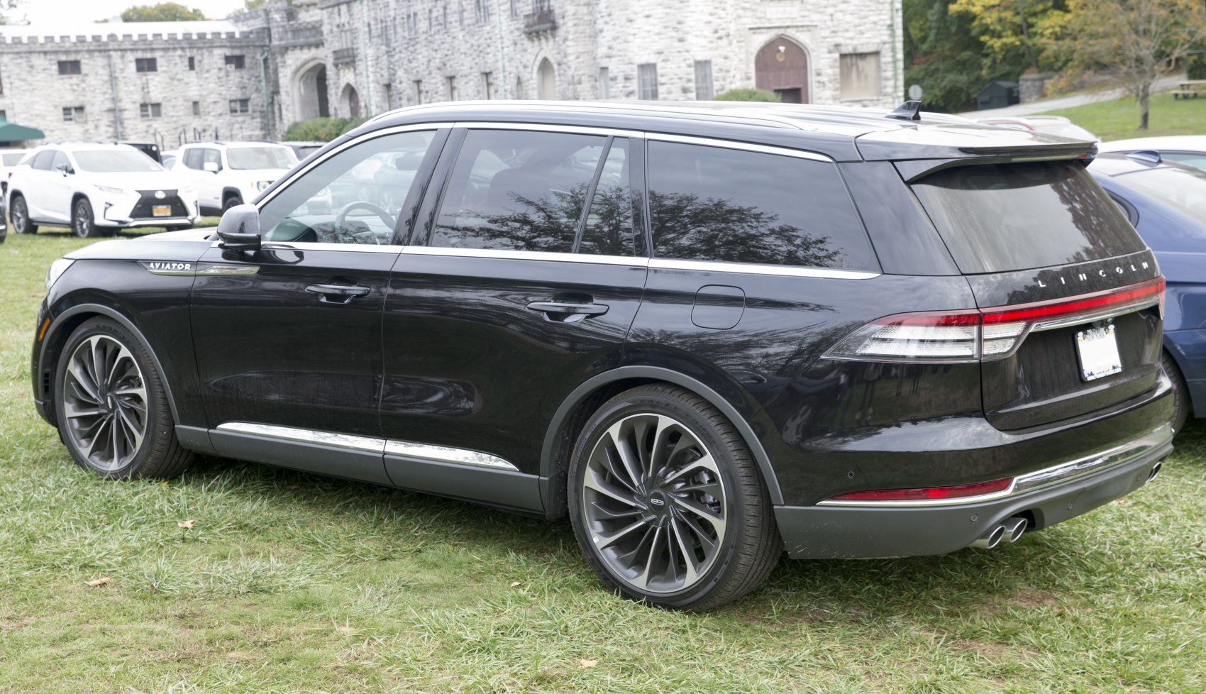 Rear side profile of black luxury SUV with alloy wheels and chrome trim