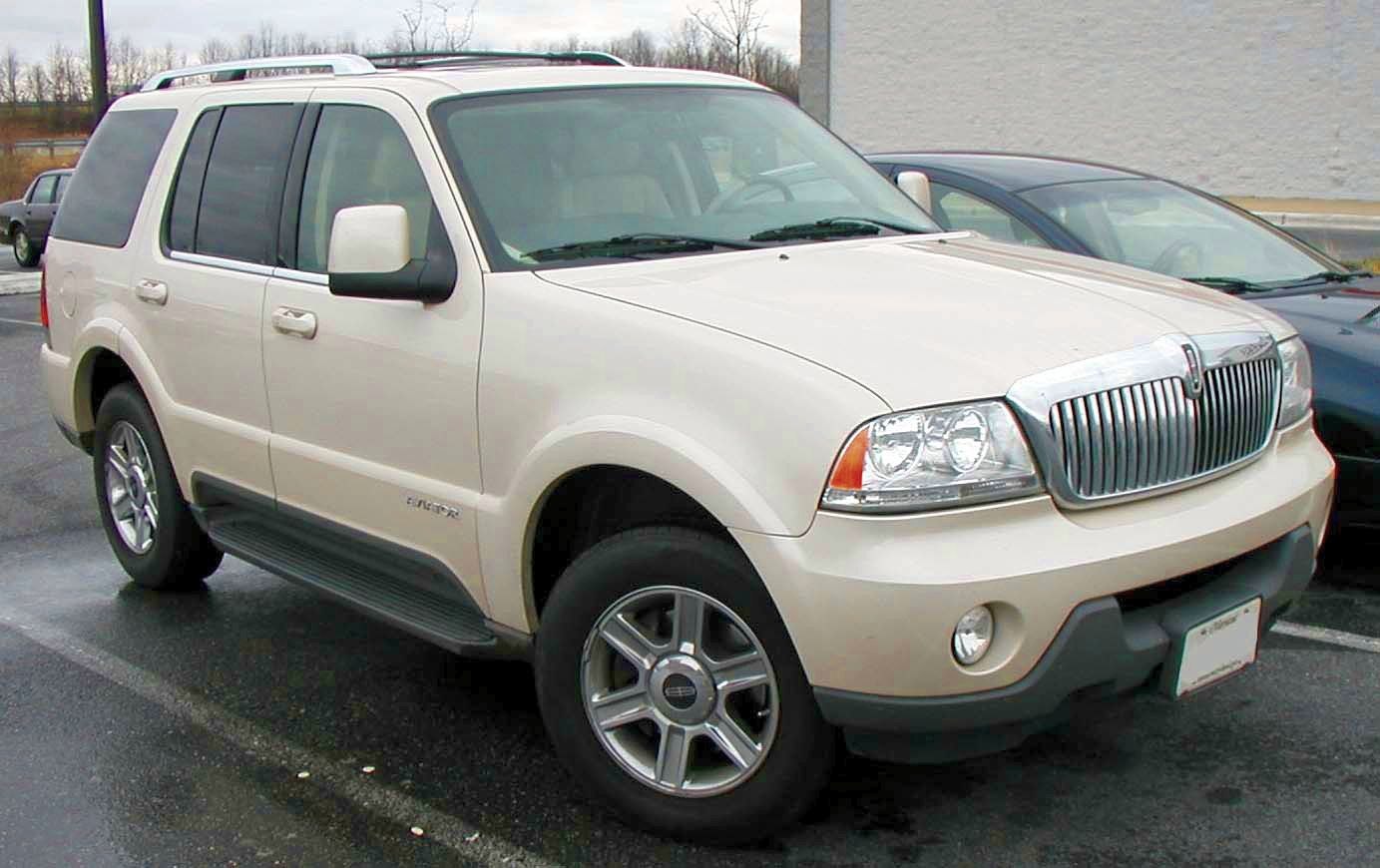 Beige SUV front-side view with distinctive grille and alloy wheels