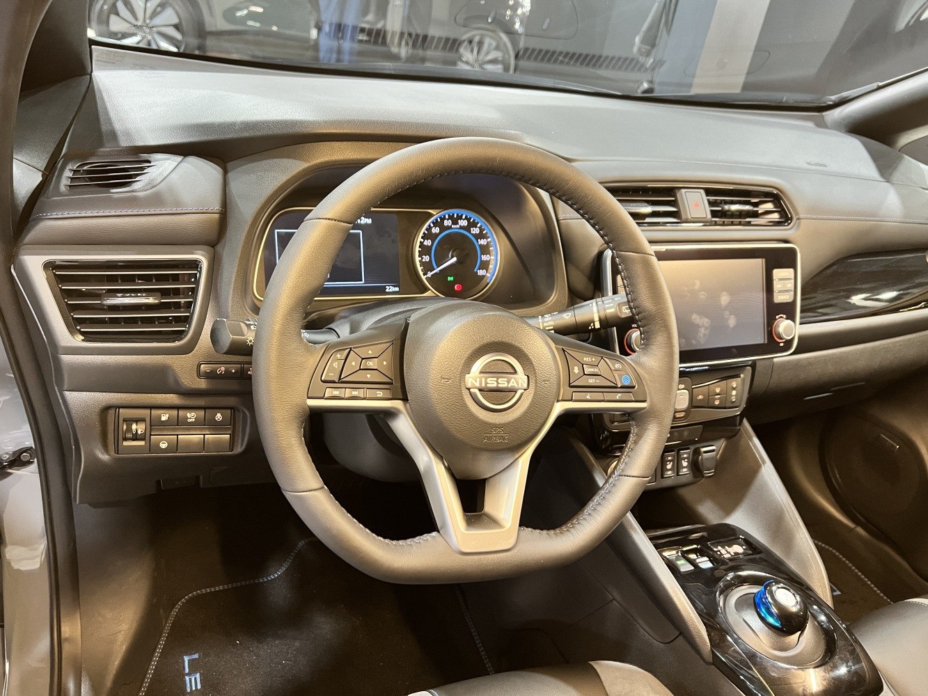Dashboard and steering wheel with digital speedometer and infotainment screen